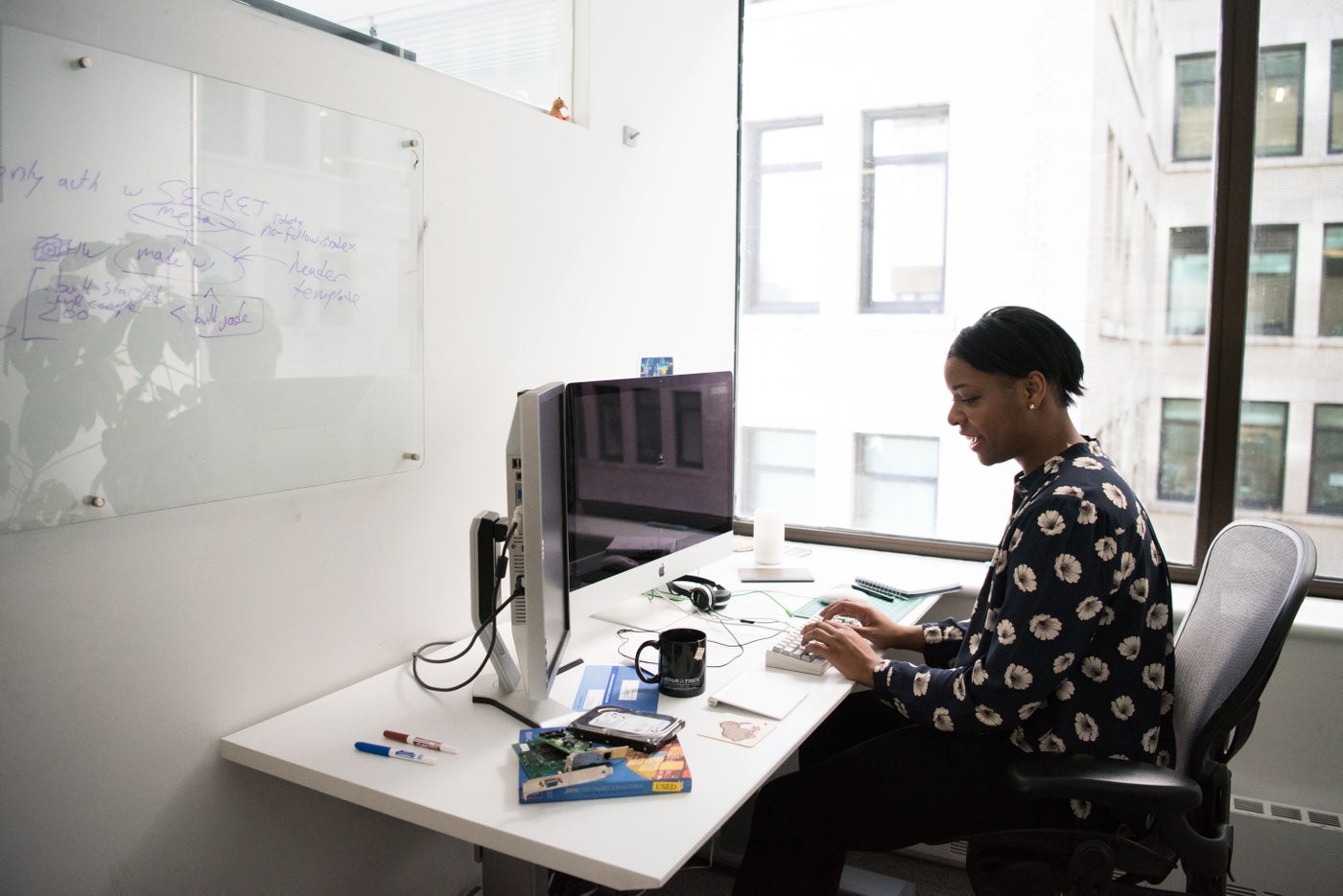 An engineer working at her desk in a bright office