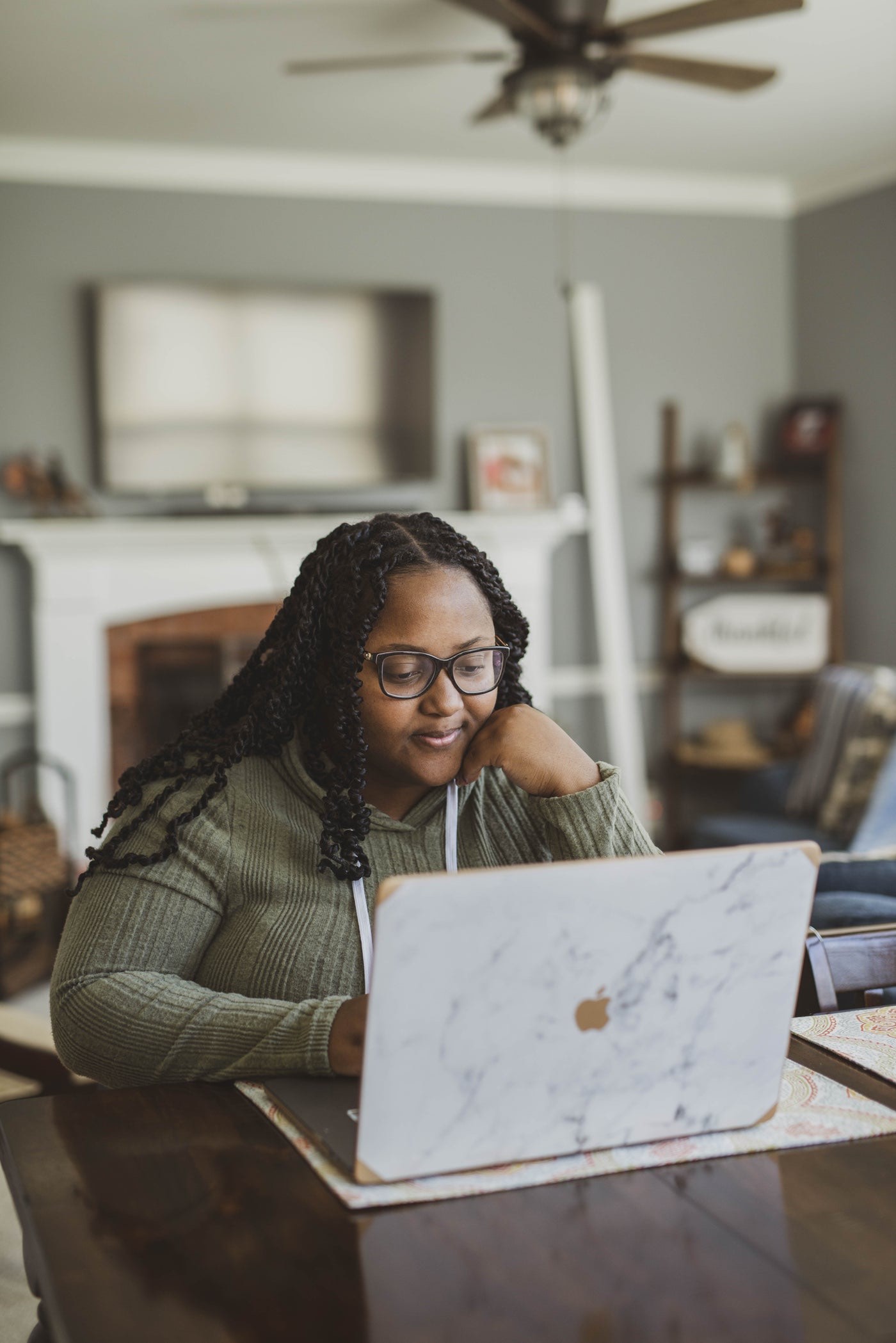 An engineer smiling while working at her laptop