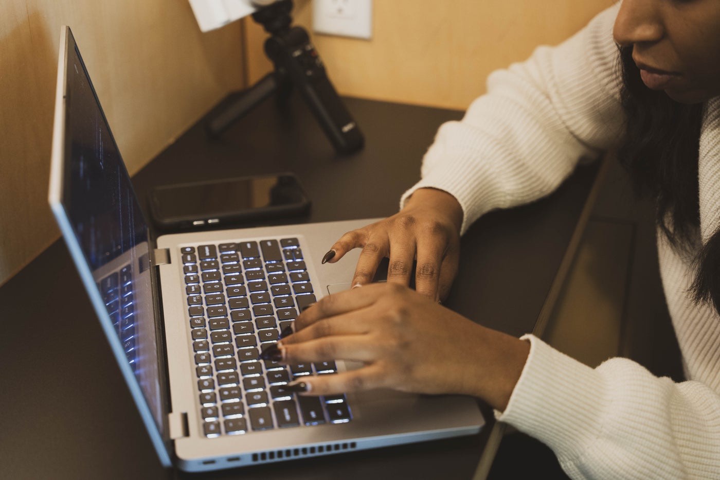 Hands typing on a laptop during a testing session