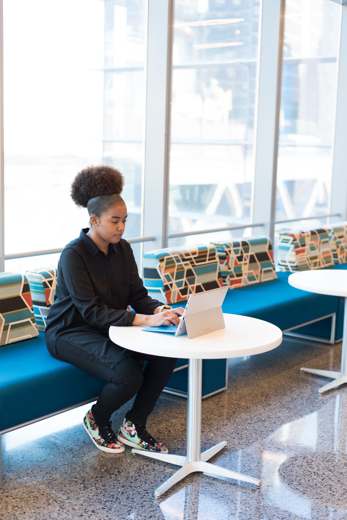 A professional working on a tablet in a bright office